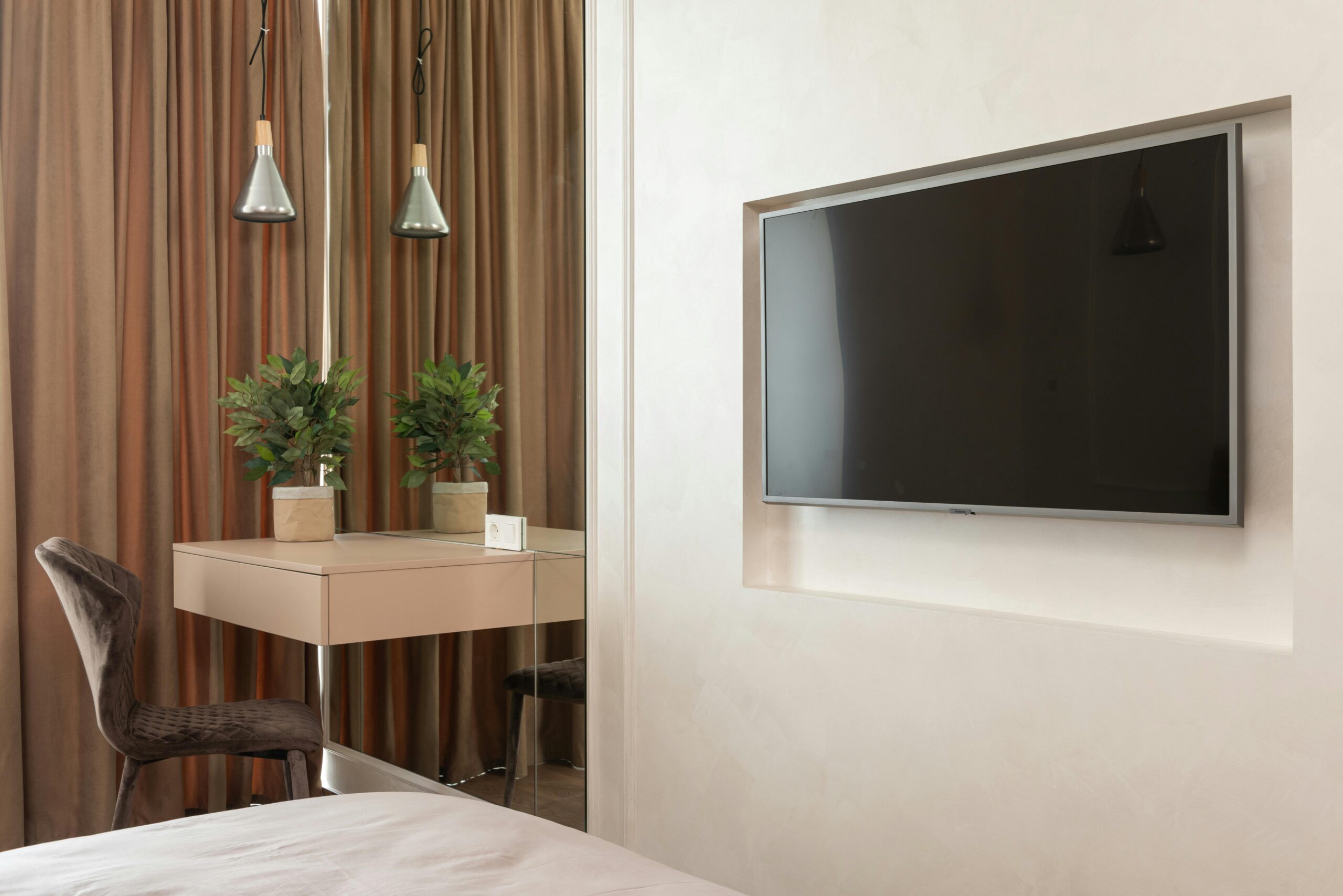 Apartment interior with TV near table with chair